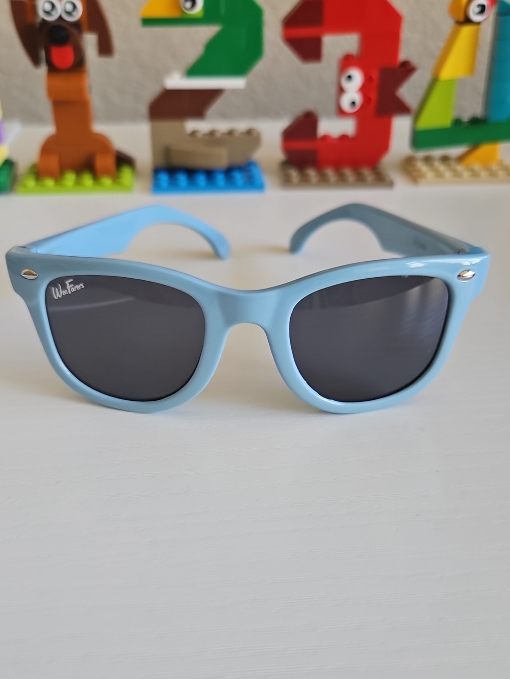 Kids Sunglasses with Toys in Background